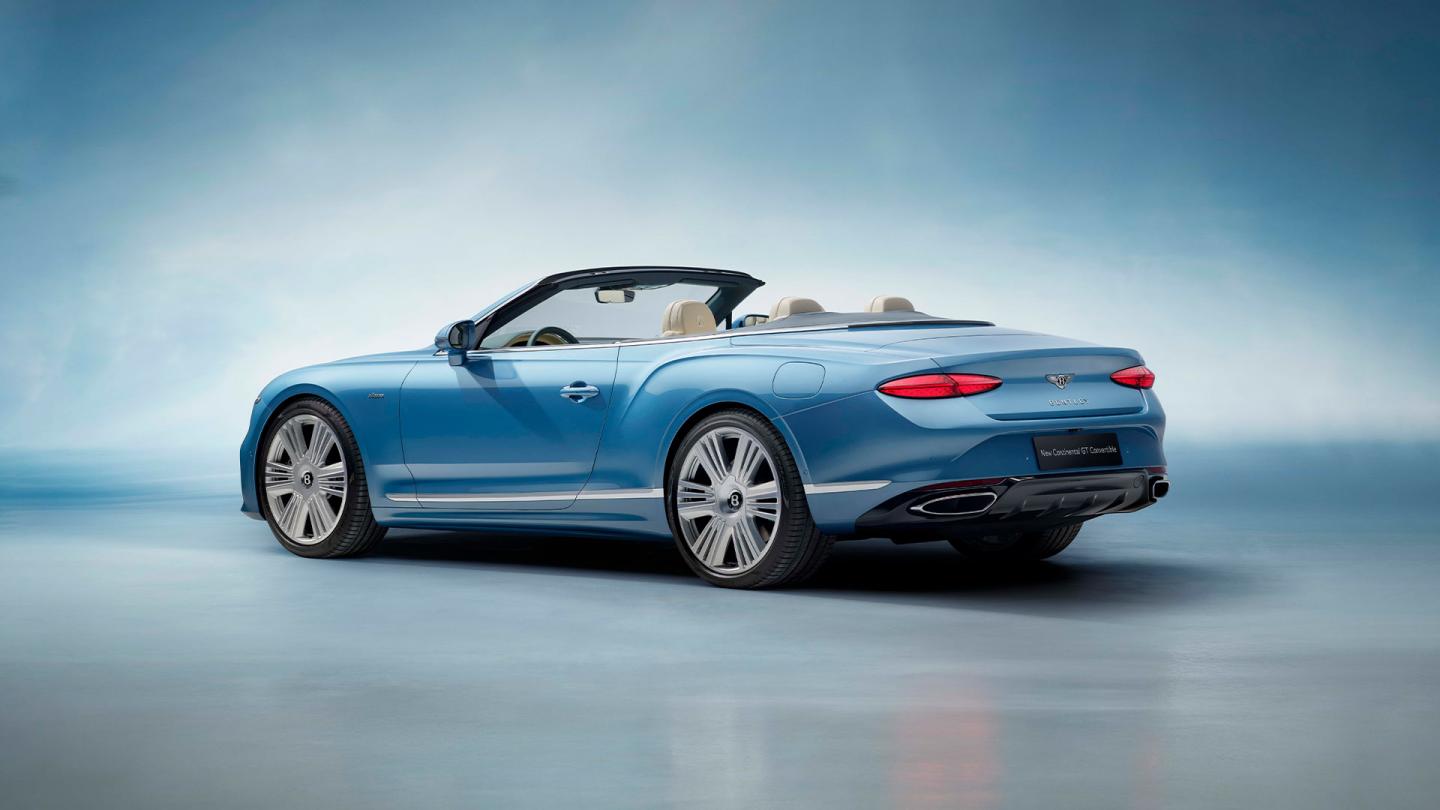 Driver side view of Bentley Continental GTC Azure V8 overlooking passenger side, featuring Portland and Imperial Blue Hide complemented by Open Pore Koa Veneer.