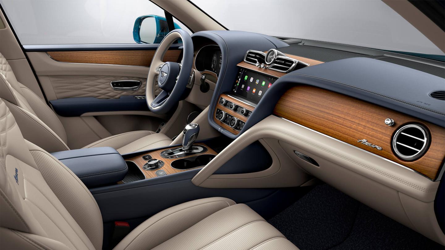 Bentley Bentayga Azure interior with Open Pore Koa veneer, view from the passenger seat over looking the driver's seat with Azure fascia.