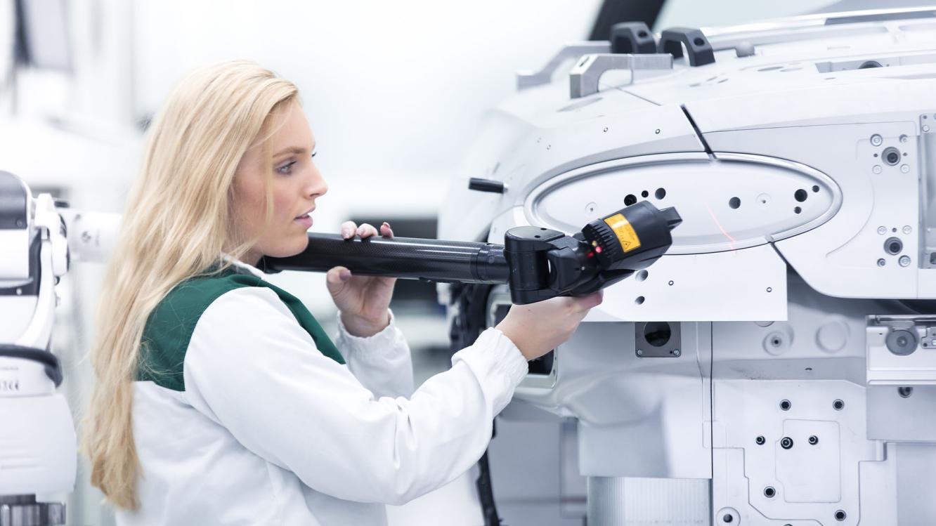 A technician working on Bentley chassis under manufacturing process.
