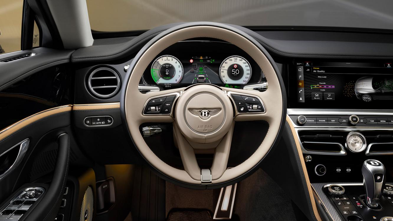 Steering wheel close up with Linen main hide and Paino veneer in the new Bentley Flying Spur Mulliner