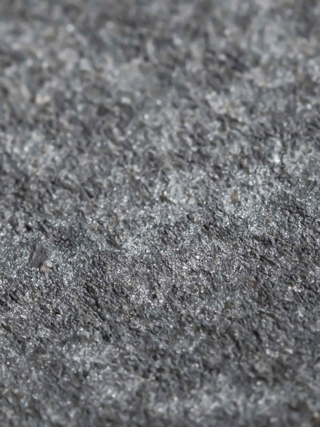 Grey stone finishing for floors and walls in Bentley Home.
